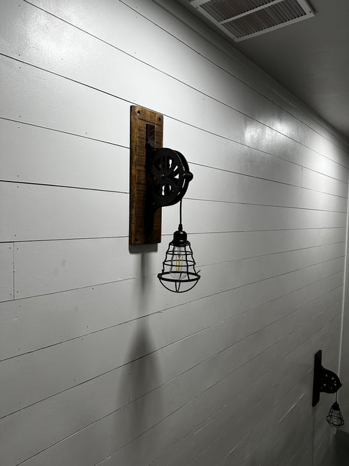 Upcycled antique pulley wall sconce