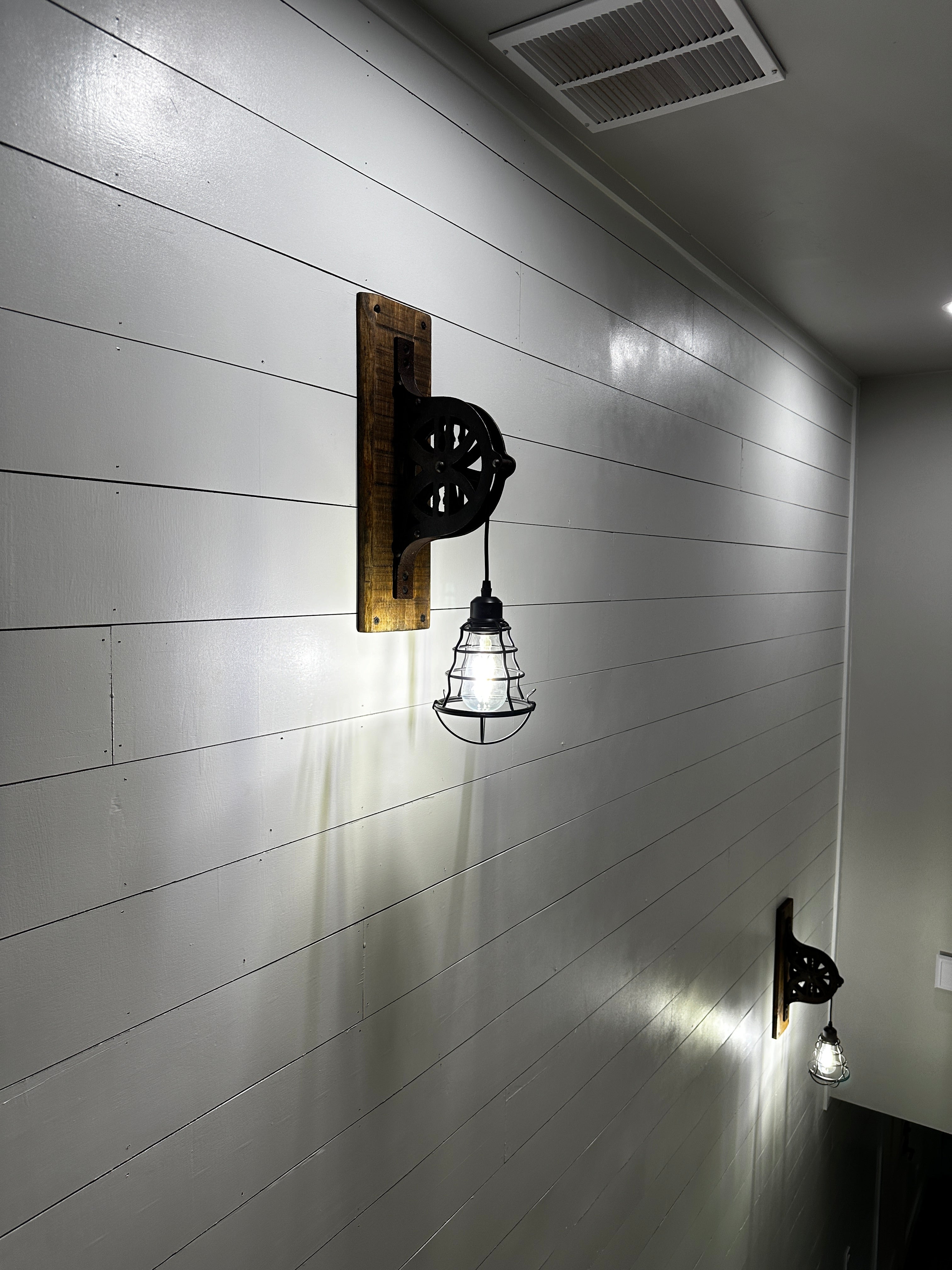 Upcycled antique pulley wall sconce